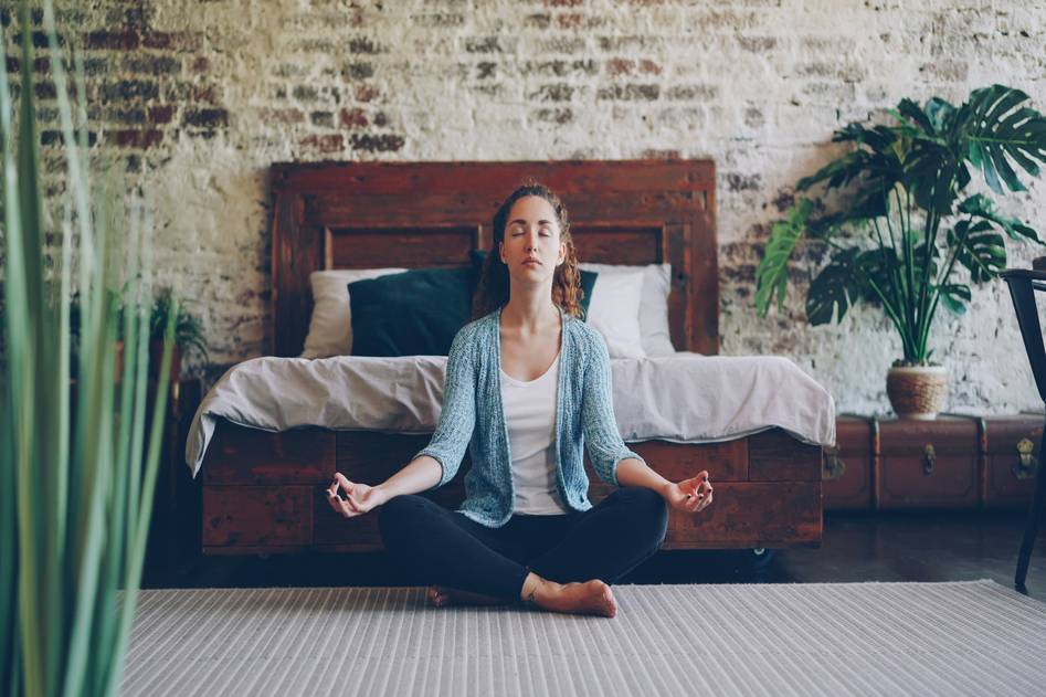 Serene person practicing deep breathing in a sunlit natural setting